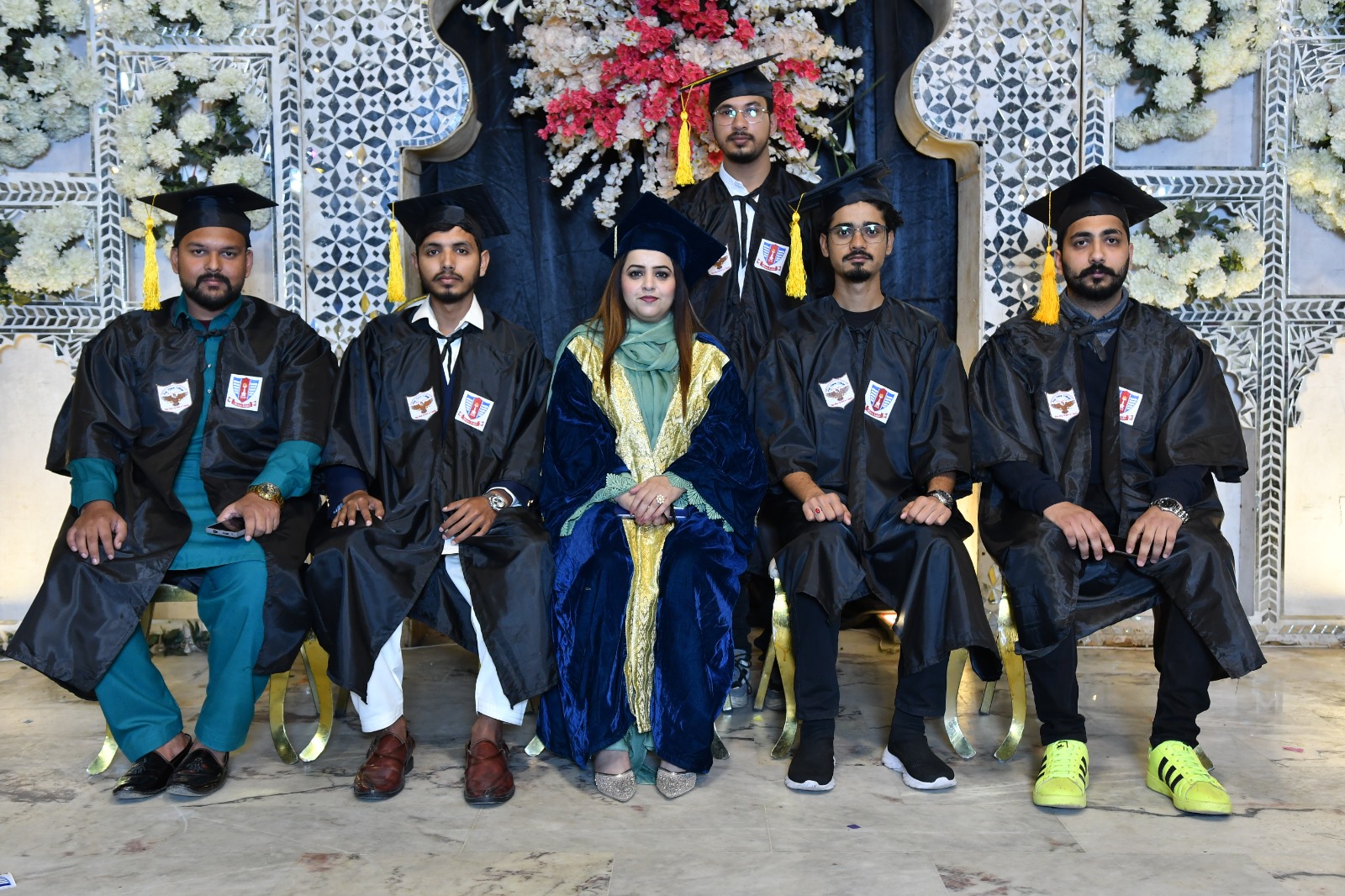 Graduating class of UEWS students in caps and gowns